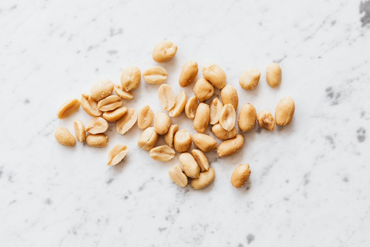 Deshelled Peanuts on White Surface